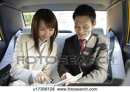 View of two professionals in a car View Large Photo Image Stock Photo - View of two professionals in a car. Fotosearch