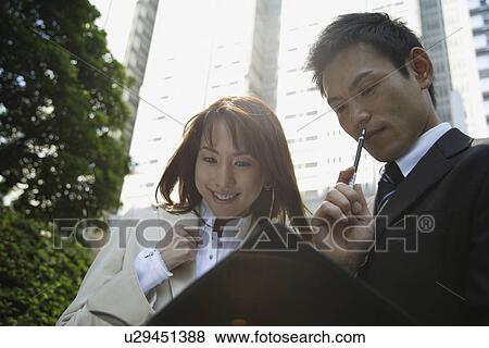 Stock Photo - View of two professionals in a conversation. Fotosearch