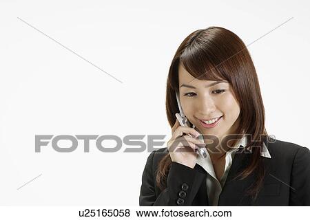 Businesswoman conversing on a cellphone, portrait View Large Photo Image Stock Photo - Businesswoman conversing on a cellphone, portrait. Fotosearch