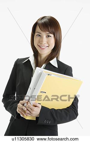 Businesswoman holding a file, portrait View Large Photo Image Stock Image - Businesswoman holding a file, portrait. Fotosearch