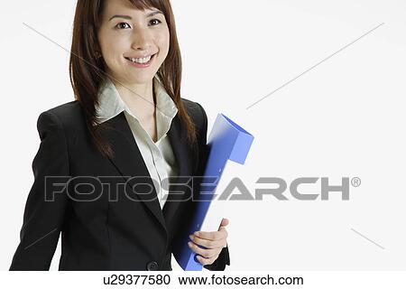 Stock Image - Businesswoman holding a file, portrait. Fotosearch