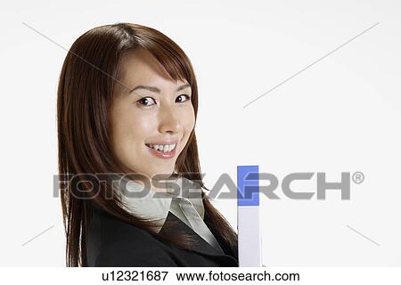 Businesswoman holding a file, portrait View Large Photo Image Stock Photo - Businesswoman holding a file, portrait. Fotosearch