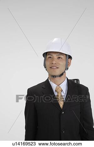 Stock Image - Cheerful executive at work, portrait. Fotosearch
