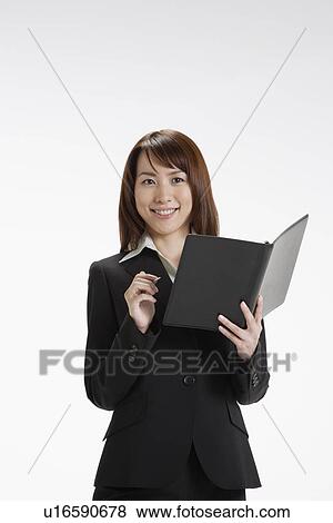 Stock Photo - Cheerful executive holding a file, portrait. Fotosearch