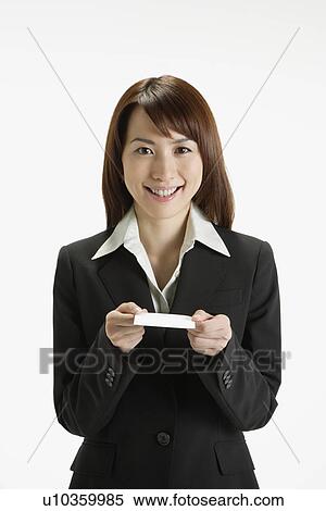 Stock Photography - Cheerful executive holding a paper, portrait. Fotosearch