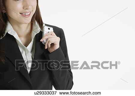 Cropped view of a businesswoman with a cellphone View Large Photo Image Stock Photo - Cropped view of a businesswoman with a cellphone. Fotosearch