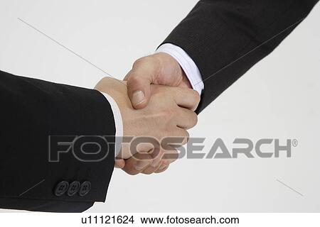 Two men shaking hands, close-up View Large Photo Image Picture - Two men shaking hands, close-up. Fotosearch
