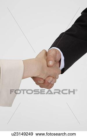 View of a man shaking hand with a woman View Large Photo Image Stock Photo - View of a man shaking hand with a woman. Fotosearch