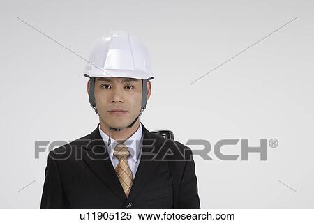 Stock Photography - View of a professional with a helmet, portrait. Fotosearch