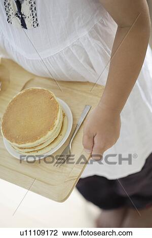 A child holding a tray with some pancakes View Large Photo Image Stock Image - A child holding a tray with some pancakes. Fotosearch