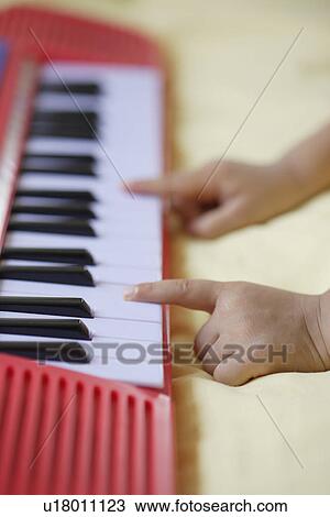 A child playing a toy organ View Large Photo Image Stock Image - A child playing a toy organ. Fotosearch
