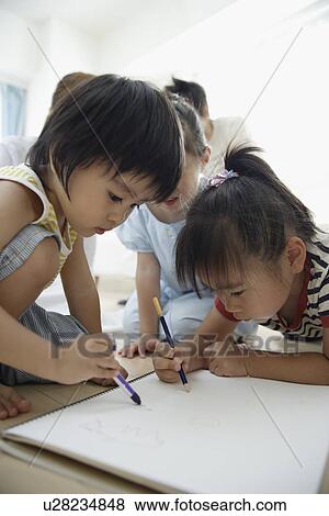 Stock Photo - Three children drawing pictures. Fotosearch