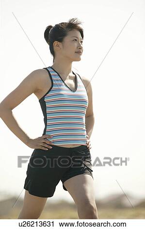 A woman exercising on a bright sunny day View Large Photo Image Stock Image - A woman exercising on a bright sunny day. Fotosearch