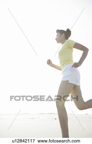 A woman jogging on the seashore View Large Photo Image Stock Photo - A woman jogging on the seashore. Fotosearch