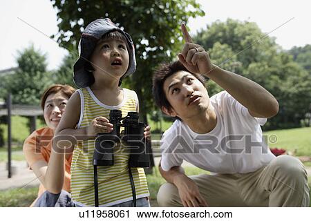 Stock Image - A boy holding binoculars . Fotosearch