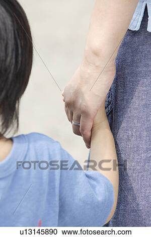 A child holding mother's hand View Large Photo Image Stock Image - A child holding mother's hand. Fotosearch