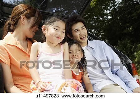 Stock Image - A family at the back of the van. Fotosearch