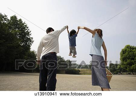 A young couple with a boy in park View Large Photo Image Stock Image - A young couple with a boy in park. Fotosearch