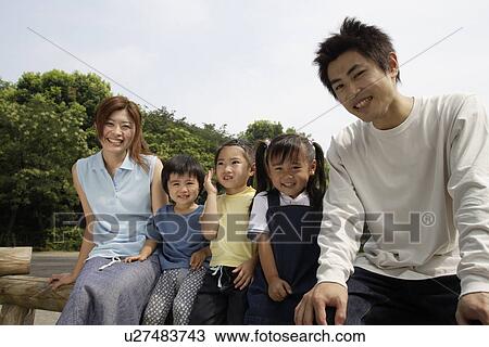 Stock Image - A young couple with three children. Fotosearch