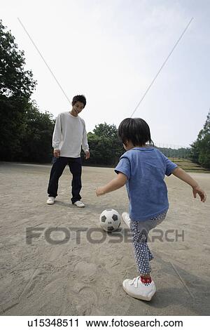 A young father playing football with his son View Large Photo Image Stock Image - A young father playing football with his son. Fotosearch