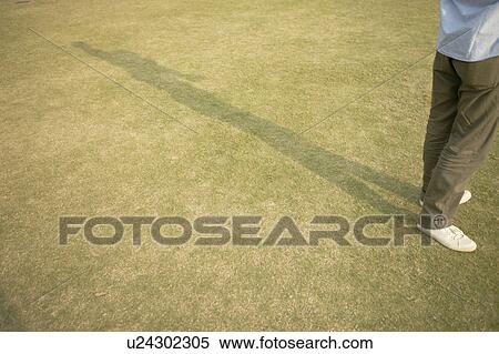 Legs of a man seen standing on the ground View Large Photo Image Stock Photography - Legs of a man seen standing on the ground. Fotosearch