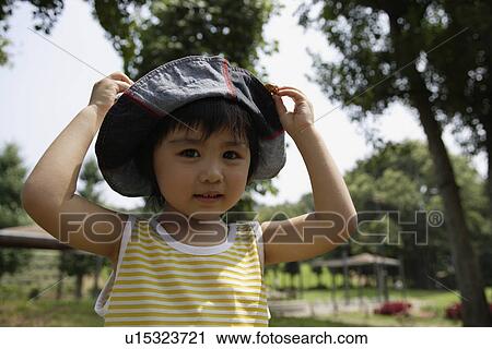 Stock Image - A boy wearing hat. Fotosearch