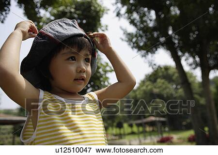Stock Photo - A boy wearing hat. Fotosearch
