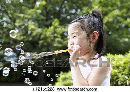 A girl blowing bubbles View Large Photo Image Stock Photo - A girl blowing bubbles. Fotosearch