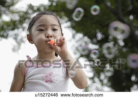 A girl blowing bubbles View Large Photo Image Stock Photograph - A girl blowing bubbles. Fotosearch