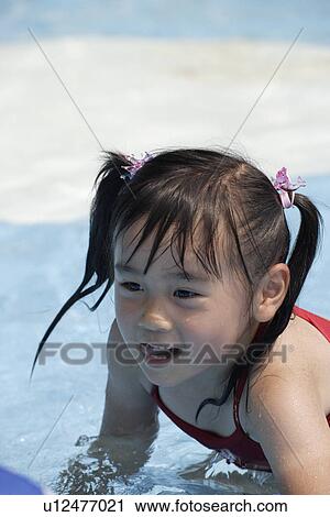 A girl in a pool View Large Photo Image Stock Image - A girl in a pool. Fotosearch