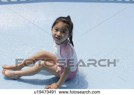 Stock Image - A girl in a pool. Fotosearch