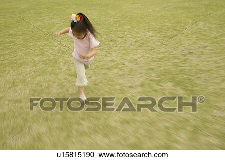 A girl running on a vast grassland View Large Photo Image Stock Image - A girl running on a vast grassland. Fotosearch