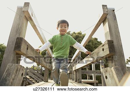 A small boy moving a step forward on the bridge View Large Photo Image Stock Image - A small boy moving a step forward on the bridge. Fotosearch