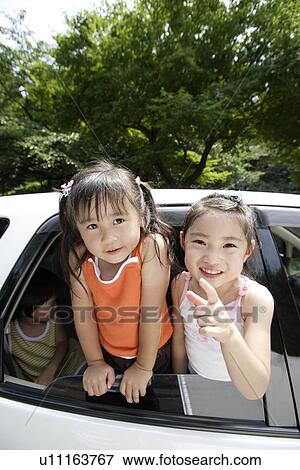 Stock Photo - Children in a car. Fotosearch
