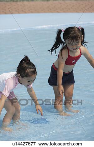 Two girls in pool View Large Photo Image Stock Photo - Two girls in pool. Fotosearch