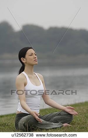 Front view of a woman in lotus position View Large Photo Image Stock Photo - Front view of a woman in lotus position. Fotosearch