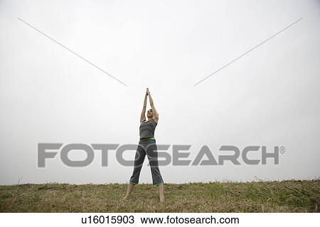 Stock Image - View of a woman with tree position. Fotosearch