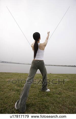 View of a young woman exercising outdoors View Large Photo Image Stock Photo - View of a young woman exercising outdoors. Fotosearch