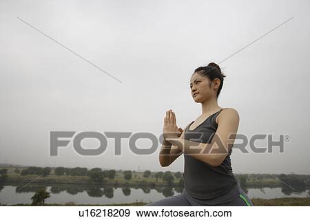 Stock Photo - View of a young woman performing yoga. Fotosearch