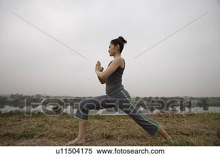 View of a young woman performing yoga View Large Photo Image Stock Photography - View of a young woman performing yoga. Fotosearch