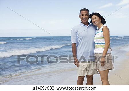 A couple smiling at beach View Large Photo Image Stock Photo - A couple smiling at beach. Fotosearch
