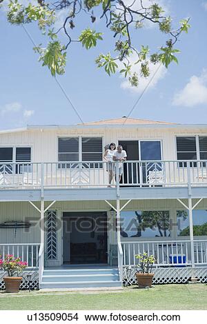 Picture - A couple standing on balcony. Fotosearch