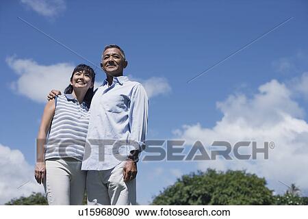 Stock Image - Low angle view of a couple. Fotosearch