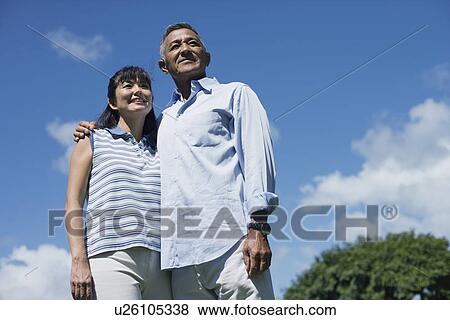 Stock Photo - Low angle view of a couple. Fotosearch