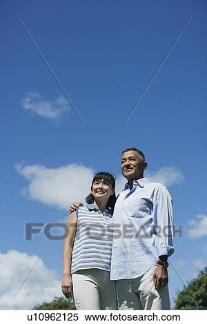 Stock Photography - Low angle view of a happy couple. Fotosearch