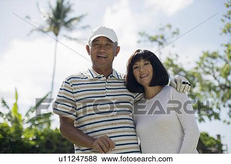 Stock Photo - View of a couple smiling. Fotosearch