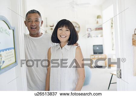 Stock Photo - View of a couple smiling. Fotosearch