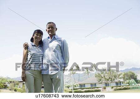 Stock Image - View of a couple standing together. Fotosearch