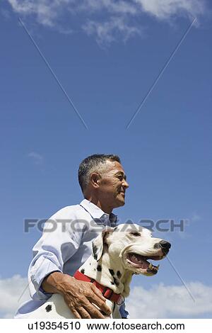 Stock Image - Profile of man with dog. Fotosearch
