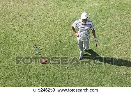 Stock Photo - Elevated view of a man standing on golf course. Fotosearch